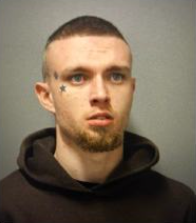 Mugshot of a young man with a star tattoo on his left cheek.